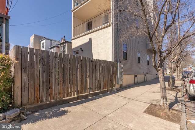 exterior space featuring stucco siding and fence