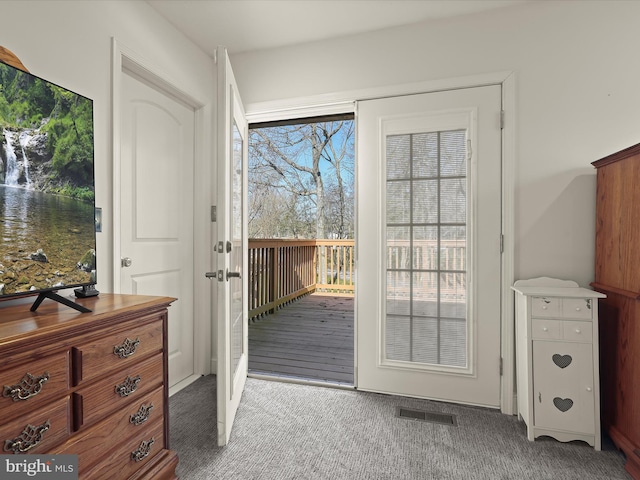 doorway with carpet flooring and visible vents
