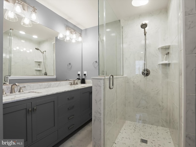 full bath featuring double vanity, a shower stall, a sink, and marble finish floor