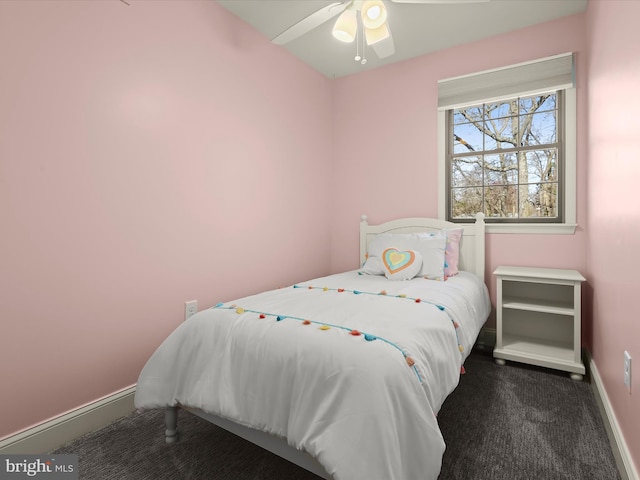 carpeted bedroom featuring baseboards and ceiling fan