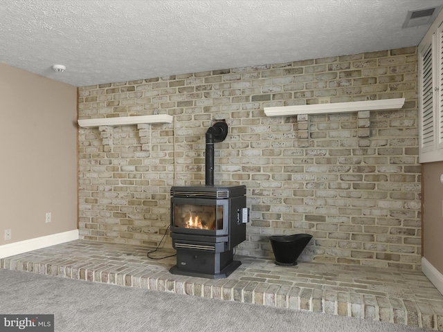 details featuring a textured ceiling, baseboards, and a wood stove