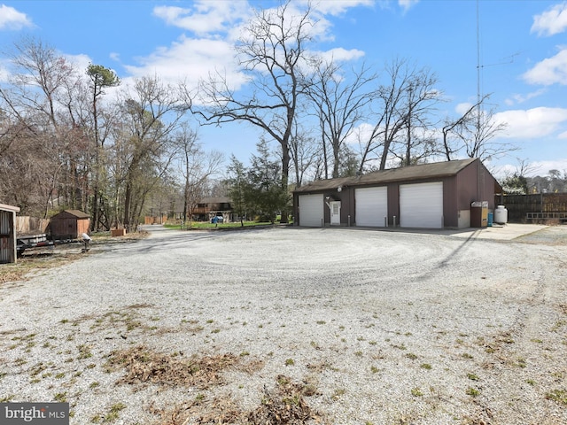 detached garage featuring fence