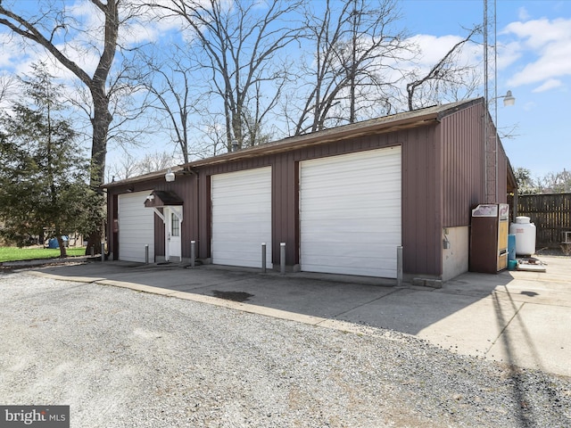 detached garage featuring fence