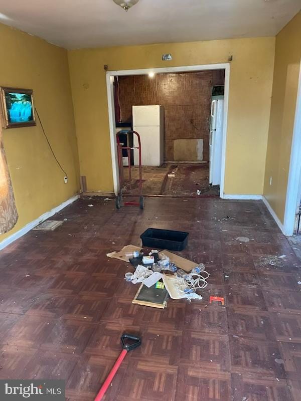 unfurnished room featuring baseboards