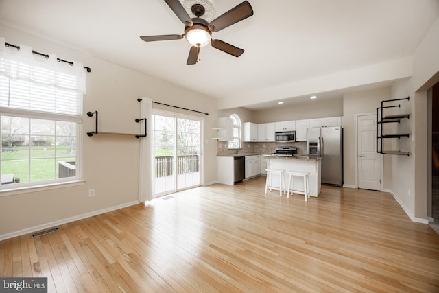 485 Lake George Cir, West Chester, PA 19382 - unfurnished living room featuring visible vents, ceiling fan, light wood-type flooring, and baseboards