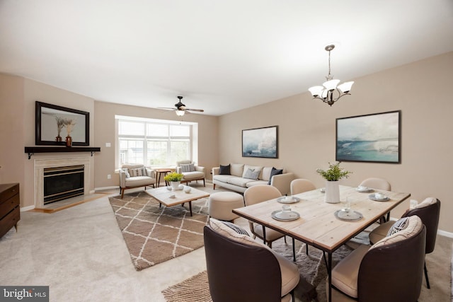 485 Lake George Cir, West Chester, PA 19382 - dining space with a glass covered fireplace, light carpet, ceiling fan with notable chandelier, and baseboards