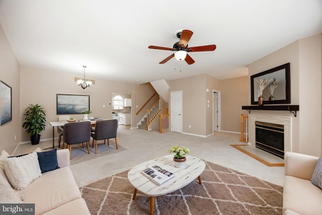 485 Lake George Cir, West Chester, PA 19382 - living room with baseboards, carpet, stairway, a fireplace with flush hearth, and ceiling fan with notable chandelier