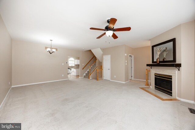 485 Lake George Cir, West Chester, PA 19382 - unfurnished living room with a fireplace with flush hearth, ceiling fan with notable chandelier, baseboards, and stairs