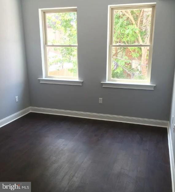 416 N Wiota St, Philadelphia, PA 19104 - spare room with baseboards and dark wood finished floors