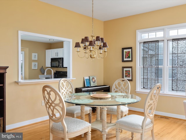 112 Daniel Ct, Strasburg, VA 22657 - dining room featuring baseboards, an inviting chandelier, and light wood finished floors