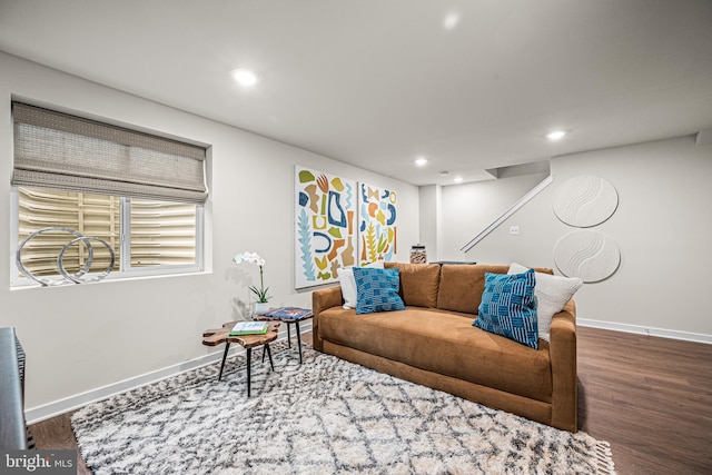 living room with recessed lighting, baseboards, and wood finished floors