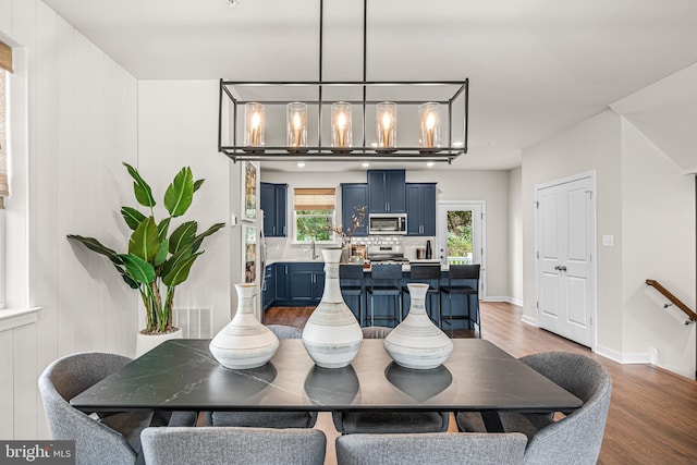 dining space featuring baseboards and wood finished floors