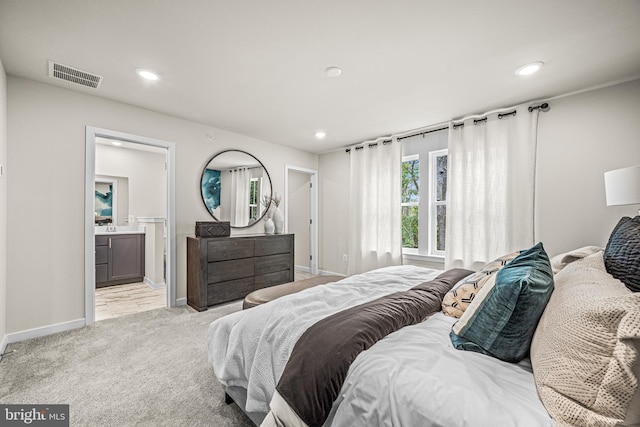 bedroom with baseboards, visible vents, recessed lighting, and light carpet