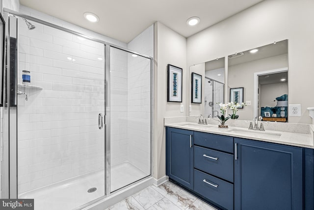 ensuite bathroom with a stall shower, a sink, ensuite bath, marble finish floor, and double vanity