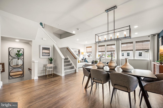 dining room featuring stairs, wood finished floors, baseboards, and recessed lighting