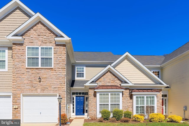 craftsman house featuring an attached garage, stone siding, metal roof, and a standing seam roof
