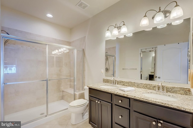 full bathroom featuring visible vents, a stall shower, a sink, and toilet