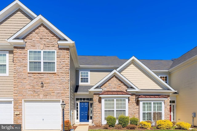 craftsman-style house featuring a garage, a standing seam roof, metal roof, and stone siding