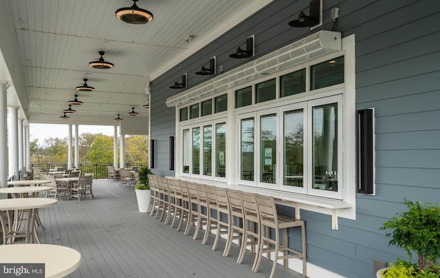 wooden terrace with outdoor dining area