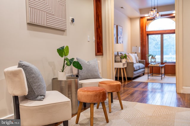 sitting room featuring a notable chandelier and hardwood / wood-style floors