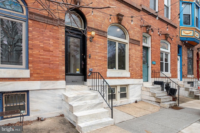 entrance to property with brick siding