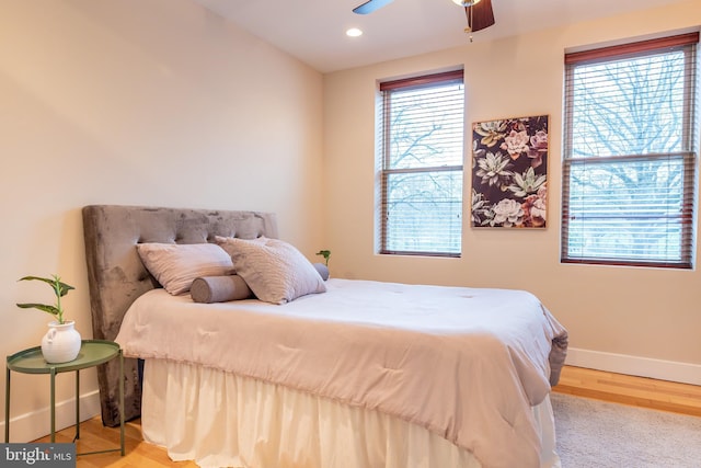 bedroom featuring baseboards, recessed lighting, wood finished floors, and a ceiling fan