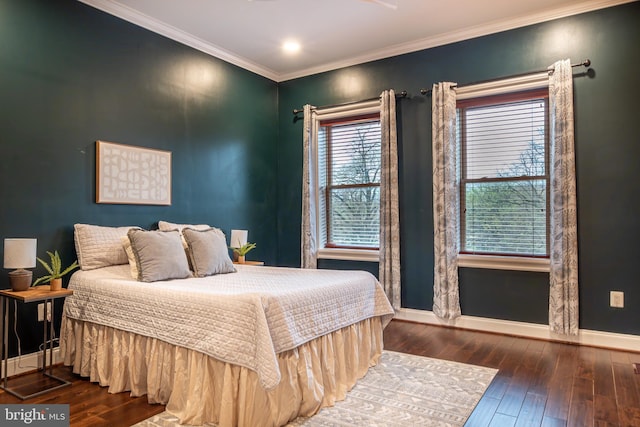 bedroom featuring wood-type flooring, baseboards, and ornamental molding