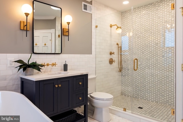bathroom featuring toilet, a stall shower, visible vents, and tile walls
