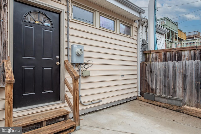 view of exterior entry featuring fence