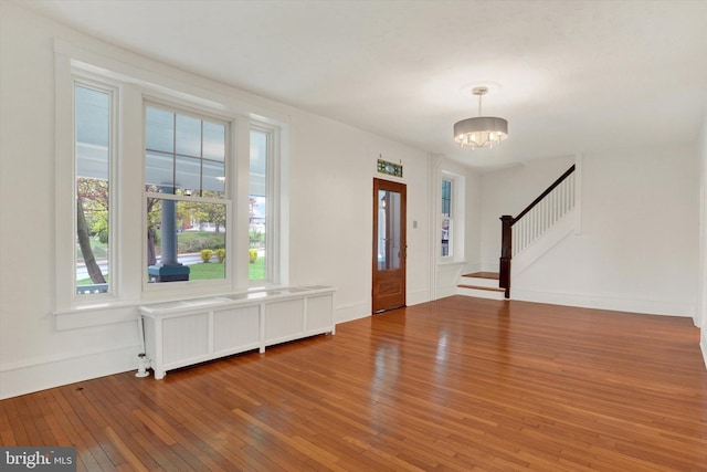 662 S Market St, Elizabethtown, PA 17022 - entrance foyer featuring radiator heating unit, wood-type flooring, stairway, a chandelier, and baseboards
