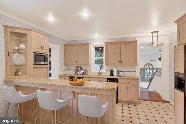 662 S Market St, Elizabethtown, PA 17022 - kitchen with light brown cabinets, stainless steel microwave, a breakfast bar area, wallpapered walls, and ornamental molding