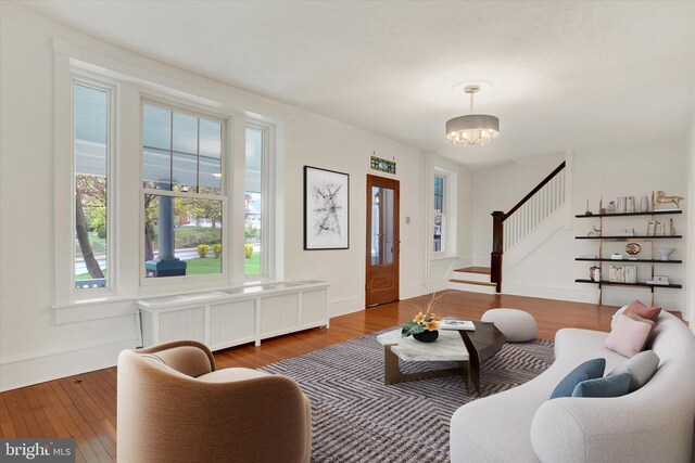 662 S Market St, Elizabethtown, PA 17022 - living room featuring stairs, wood-type flooring, a chandelier, and radiator heating unit
