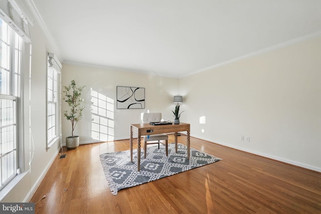 home office featuring visible vents, ornamental molding, baseboards, and wood finished floors