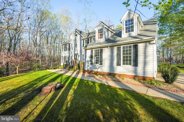 view of side of home featuring a lawn