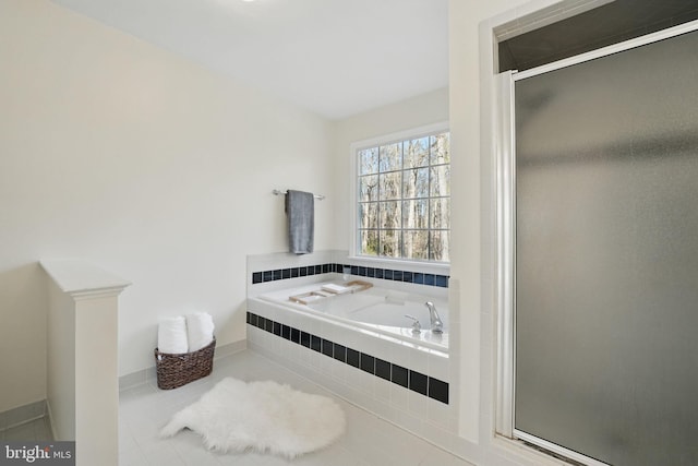 full bathroom with a stall shower, a garden tub, and tile patterned flooring