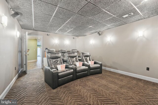 home theater featuring carpet flooring, baseboards, and visible vents