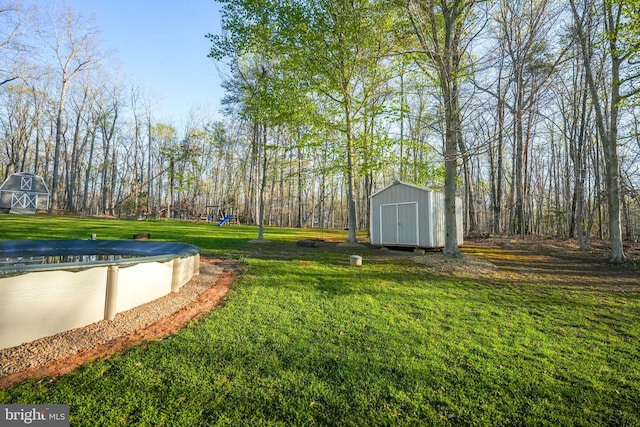view of yard featuring a storage shed and an outdoor structure