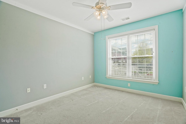 unfurnished room with baseboards, a ceiling fan, visible vents, and carpet