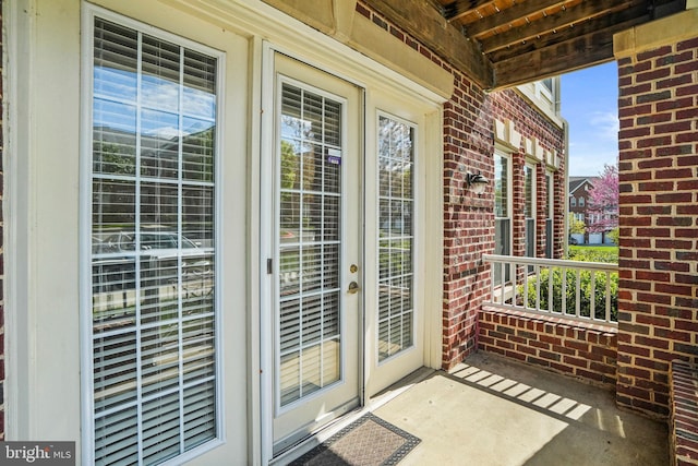 doorway to property with brick siding