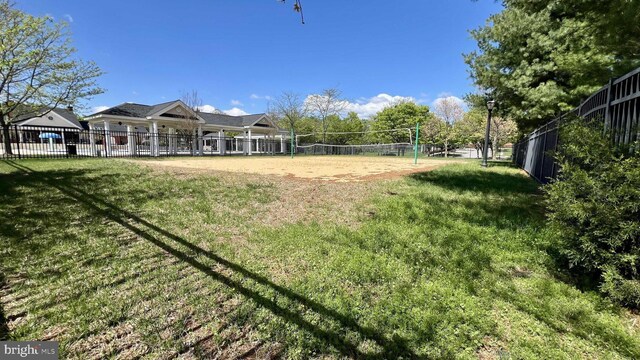 exterior space featuring a yard, volleyball court, and fence