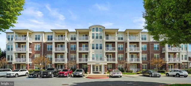 view of building exterior with uncovered parking