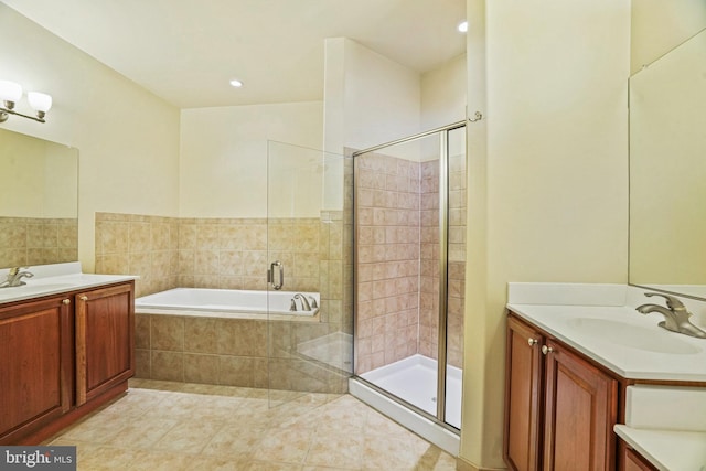 full bathroom with a bath, a sink, and a stall shower