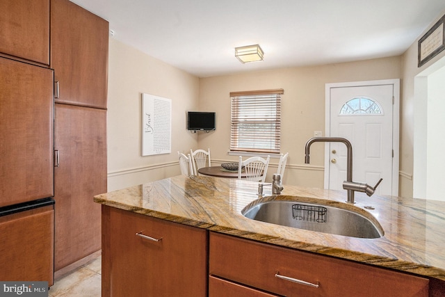1057 Fitzwatertown Rd, Roslyn, PA 19001 - kitchen with fridge, brown cabinets, a sink, and light stone counters