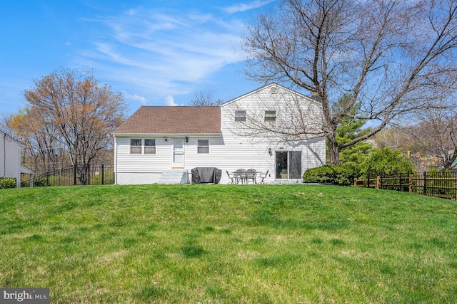 1057 Fitzwatertown Rd, Roslyn, PA 19001 - rear view of house with fence, a shingled roof, and a lawn