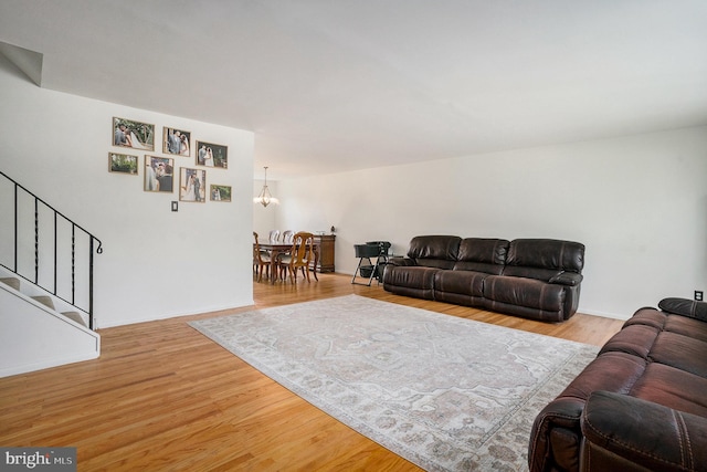1057 Fitzwatertown Rd, Roslyn, PA 19001 - living room featuring baseboards, an inviting chandelier, wood finished floors, and stairs