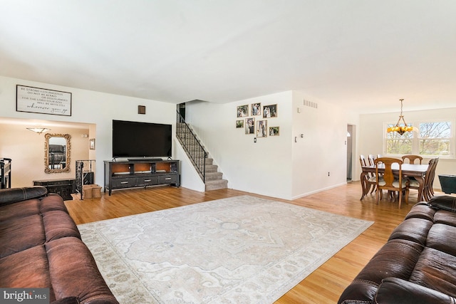 1057 Fitzwatertown Rd, Roslyn, PA 19001 - living area with visible vents, stairway, a notable chandelier, and wood finished floors