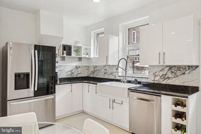 251 S 46th St, Philadelphia, PA 19139 - kitchen with a sink, stainless steel appliances, open shelves, white cabinetry, and decorative backsplash