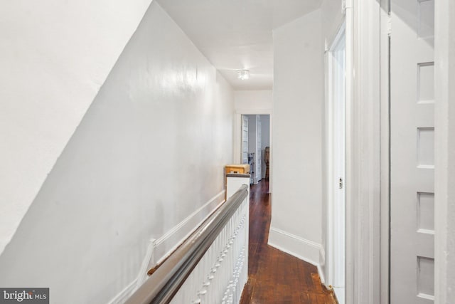 251 S 46th St, Philadelphia, PA 19139 - hallway with dark wood-style flooring, baseboards, and an upstairs landing