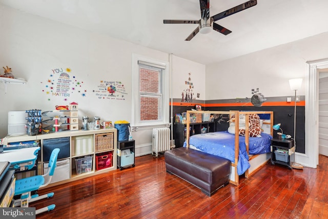 251 S 46th St, Philadelphia, PA 19139 - bedroom with baseboards, hardwood / wood-style floors, radiator heating unit, and a ceiling fan