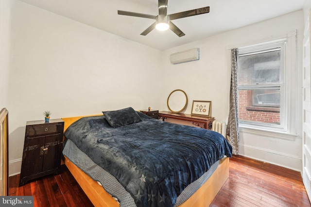 251 S 46th St, Philadelphia, PA 19139 - bedroom with radiator heating unit, dark wood-type flooring, a wall mounted AC, a ceiling fan, and baseboards